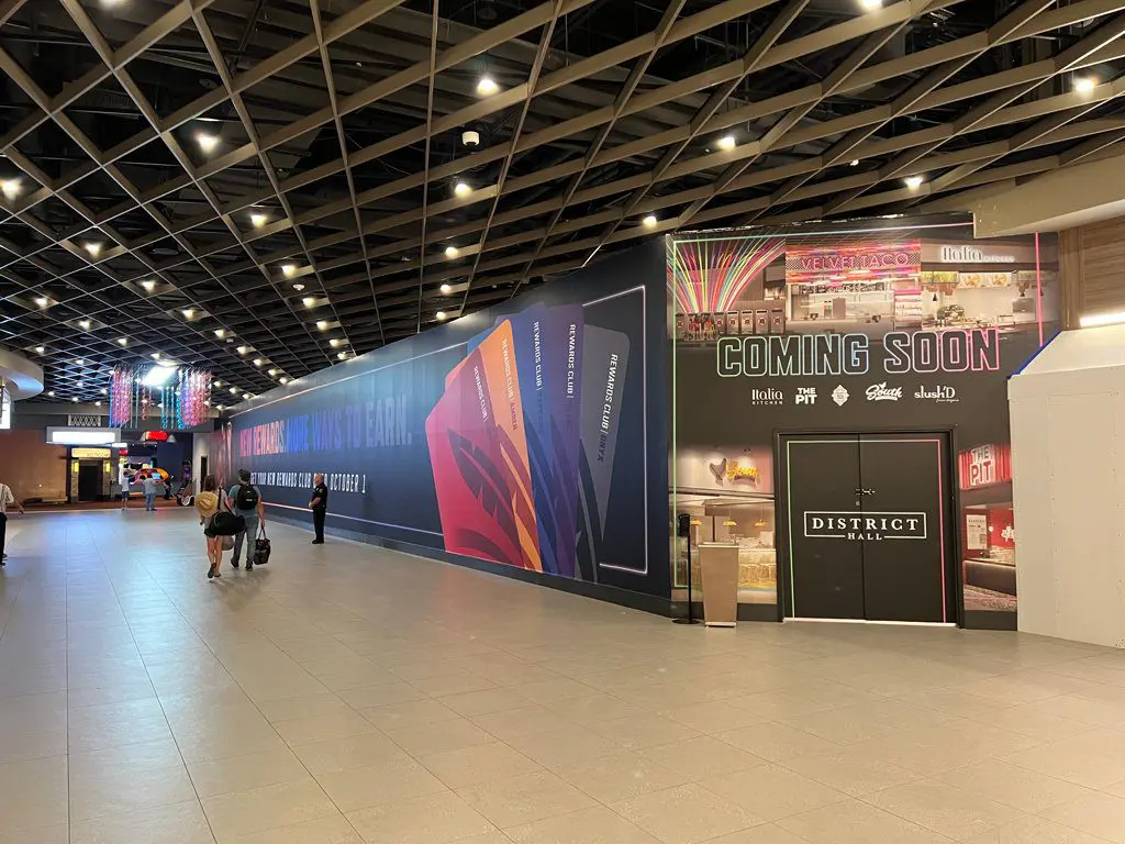 A large wall in the middle of an airport.