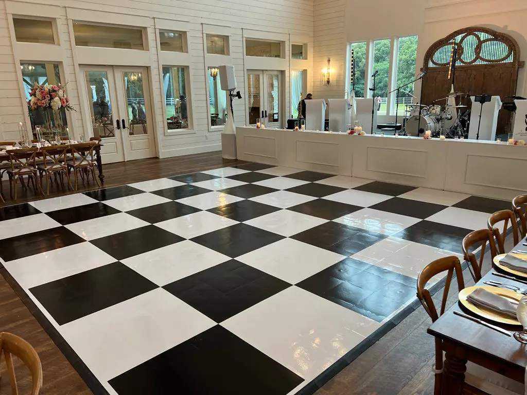 A black and white checkered dance floor in the middle of a room.