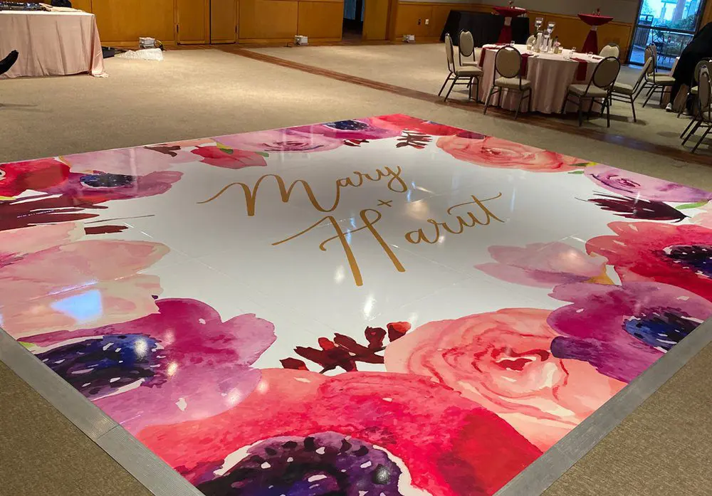 A floor with flowers and gold lettering on it.