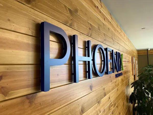 A wooden wall with the word phoenix on it.