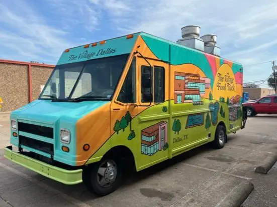 A food truck parked on the side of a road.