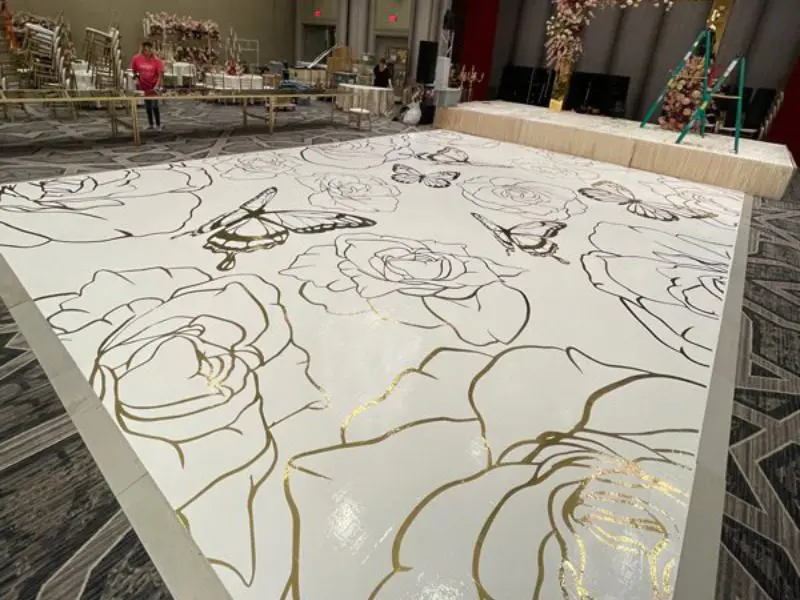 A large white table with gold lines on it.